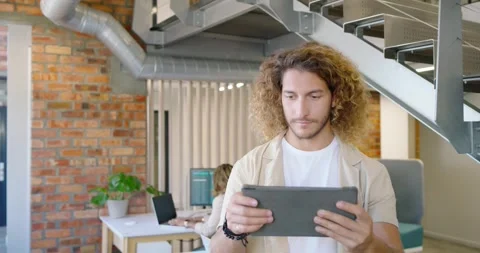 Diverse team watching man standing under stair reading tablet tapping screen Stock Footage 337944478