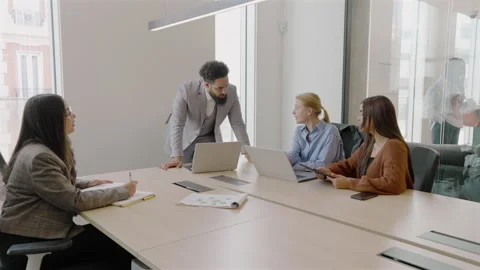 A Diverse Team Working Together and Collaborating Effectively in a Modern Office Stock Footage 306042293