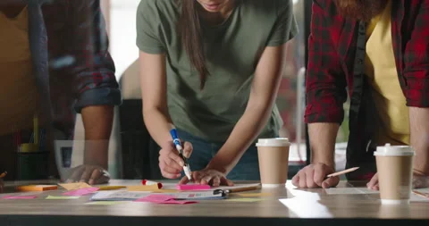 Diverse team of young office workers having brainstorming session, energetically Stock-Footage 156300339