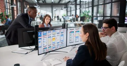 Diverse Team Of Young Professionals Developing Websites On Computer Screens. Stock Photos
