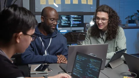 Diverse Team of Young Programmers Designing Software in Dimly Lit IT Office Video stock 329614183