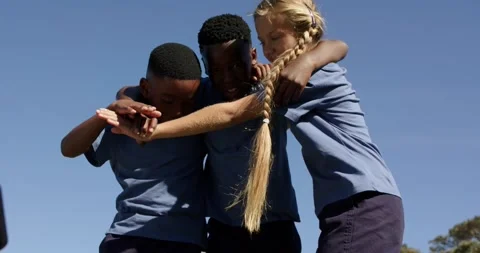 Diverse teens in uniform joining hands, starting cheer, braid falling, raising Stock Footage 344948535