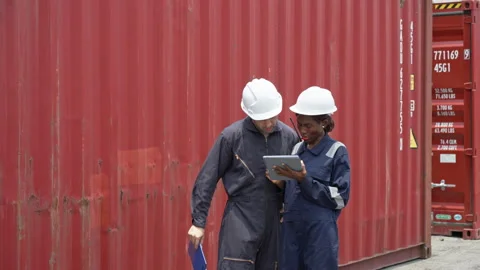 Diverse Two Workers in Coveralls Consulting at Shipping Container Yard Duri.. Stock Footage 336399442