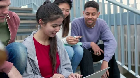 Diverse university students doing homework or grupal project together on laptop Stock Footage 237365651