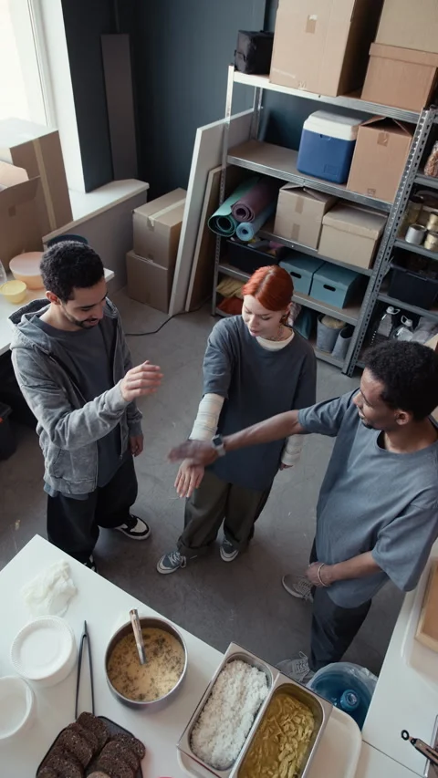 Diverse Volunteers Stacking Hands for Teamwork in Food Bank Stock Footage 339072528