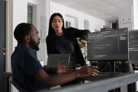 Diverse web developers working on software development with source code Stock Photos