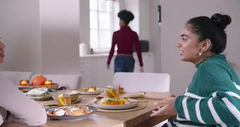 Diverse women at dining table watching woman in burgundy speaking, retrieving Stock Footage 339230935