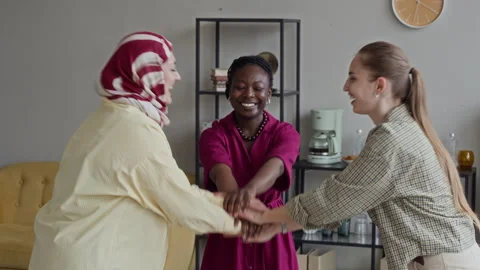 Diverse Women Stacking Hands Celebrating Success in Office Stock Footage 341565628