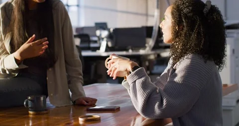 Diverse women team starting work talk at wooden table, speaker gesturing with Stock Footage 345839956