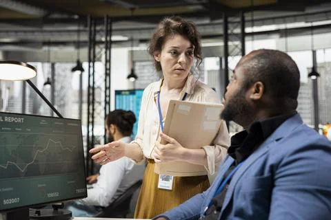 Diverse work team handling project briefing in a corporate office Stock Photos