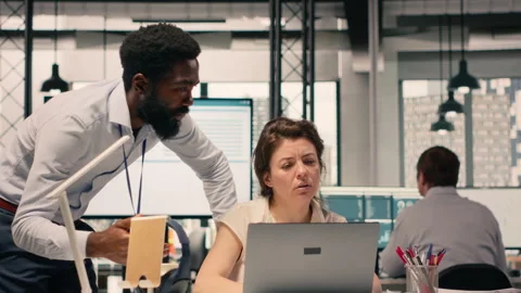 Diverse work team in a multinational company office discussing forecasting Stock Footage 329330956