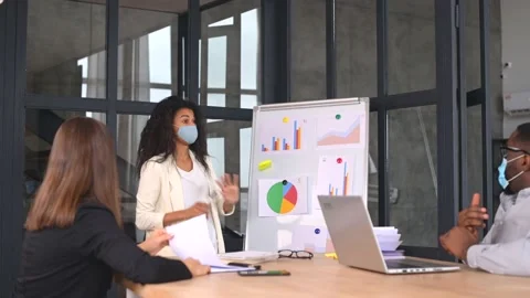 Diverse work team in protective medical masks working in office during pandemic Stock Footage 151435314