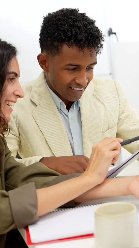 Diverse young colleagues collaborating in a modern office Stock Footage 318210003