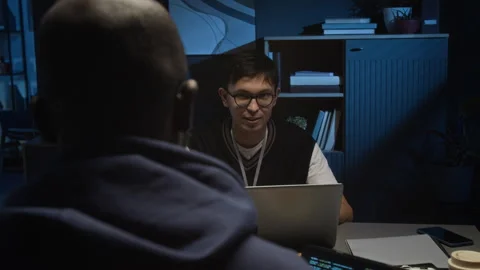 Diverse Young IT Specialists Working on Project and Conversing in Dark Office Stock Footage 329614919