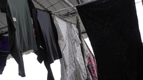 Diversified Clothing Hanging - A Dynamic Display of Laundry in Motion Stock Footage 318484953