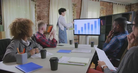 Diversity group working together on project in office Stock Footage 111721133