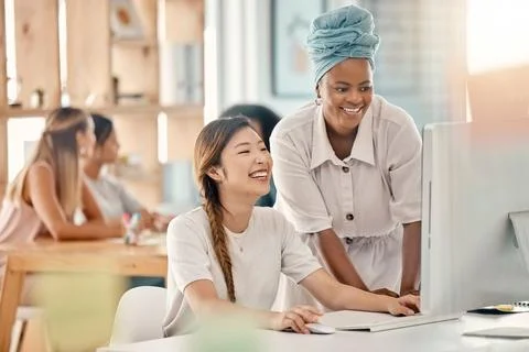 Diversity, help or training at computer in web design company office Stock Photos