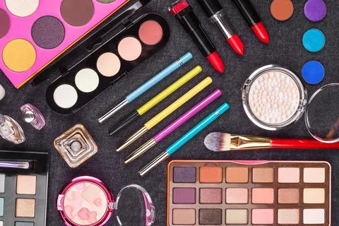 Diversity of makeup tools on gray background Stock Photos