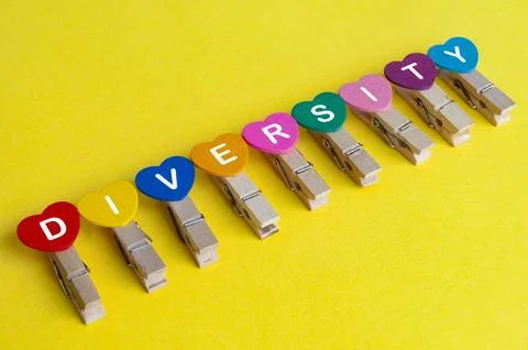 Diversity text on hearth shape on yellow background Stock Photos