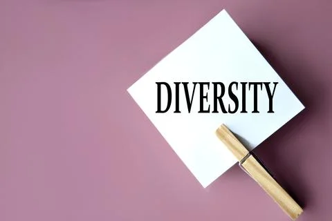 DIVERSITY - word on white sheets of paper with clothespins on a coffee back.. Stock Photos