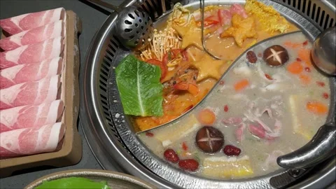 Divided Hot Pot Cooking with Two Broths and Sliced Meat Видео 346715783