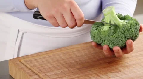 Dividing broccoli into florets Stock Footage 24672655