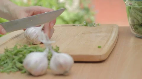Dividing cloves of garlic with the help of knife outdoors Stock Footage 8367592