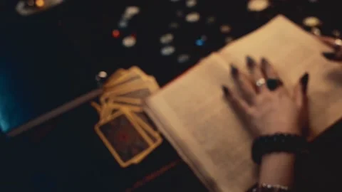 Divination and magic. A fortune teller leafs through a book of spells Stock-Footage 141851300