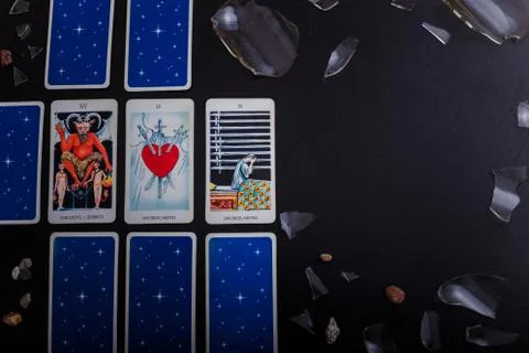 Divination cards alignment. Devil and swords. Background with broken glass Foto stock