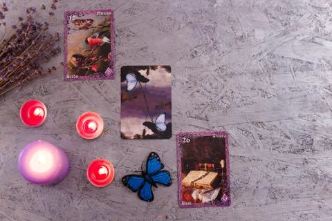 Divination cards alignment with purple burning candle and dry lavender Stock Photos