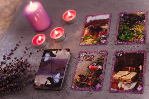 Divination cards alignment with purple burning candle and dry lavender Stock Photos