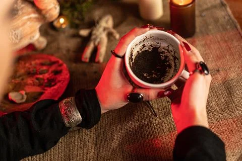 Divination on coffee grounds. The witch guesses the fate of man over coffee. Stock Photos
