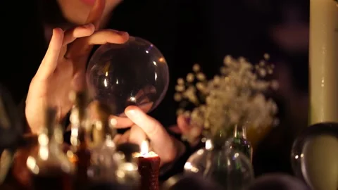 Divination on a crystal ball next to burning candles 스톡 동영상 130215311