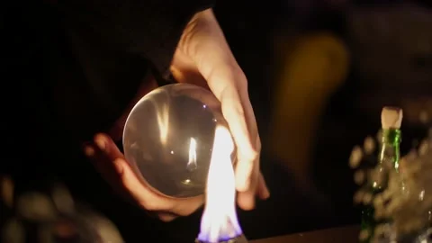 Divination on a crystal ball next to burning candles 스톡 동영상 130215598