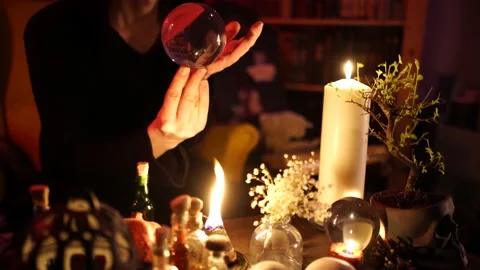 Divination on a crystal ball next to burning candles 스톡 동영상 130249290