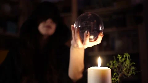 Divination on a crystal ball next to burning candles 스톡 동영상 133076999