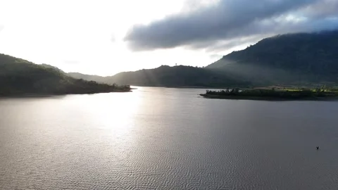 Divine Light: Cinematic Aerial View of Sunbeams Over a Mountain Lake 스톡 동영상 342774247