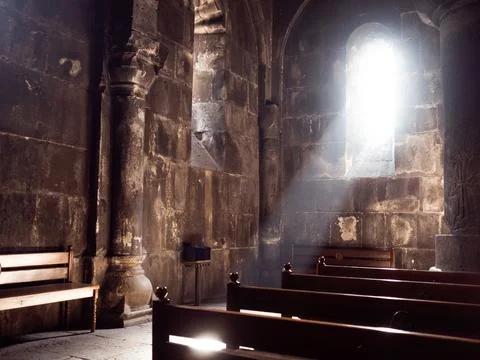 Divine light falls on the bench for prayer, the interior of an ancient church, Stock Photos