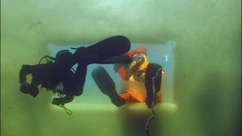 Diving below arctic ice two divers exploring the white sea realm Stock Footage 314132605