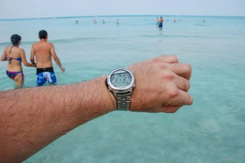 Diving clock on the background of the sea with a time difference Stock Photos