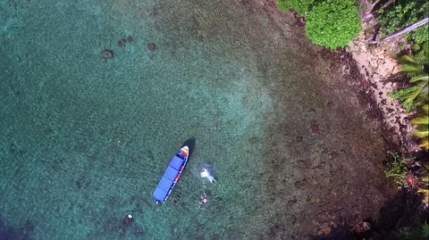 Diving into crystal clear waters from the deck of a boat drone view Stock Footage 90524854