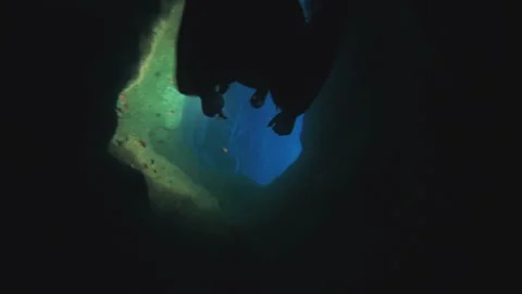 Diving into a depth cave tunnel Stock Footage 130183303