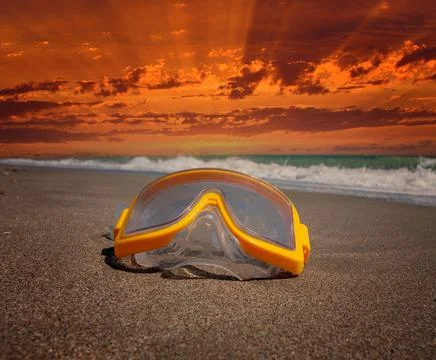 Diving goggles on the sandy seashore Stock Photos