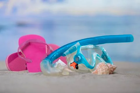 Diving goggles with seashells and flip flops Stock Photos