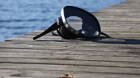 Diving mask at the edge of the water bridge. Stock Footage 68784510