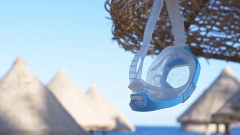 Diving mask  hanging on the umbrella. Stock Footage 83166201