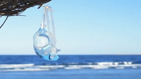 Diving mask  hanging on the umbrella. Stock Footage 83166287