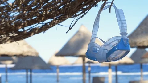 Diving mask  hanging on the umbrella. Stock Footage 83166290