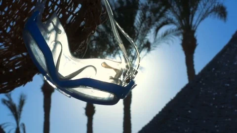 Diving mask  hanging on the umbrella. Stock Footage 83166333