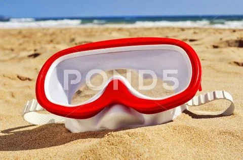 Diving mask in the sand of a beach Stock Photos